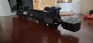 11" AR9 upper receiver assembly with a short-barrel configuration, a multi-port muzzle brake, rail sections, and flip-up sights