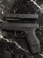 Firearm Components on Black Marble.webp